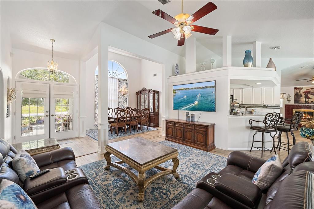 A living room with leather sofas, a marble coffee table, and an adjacent dining area — 1687 WISE DRIVE, NORTH PORT, FL
