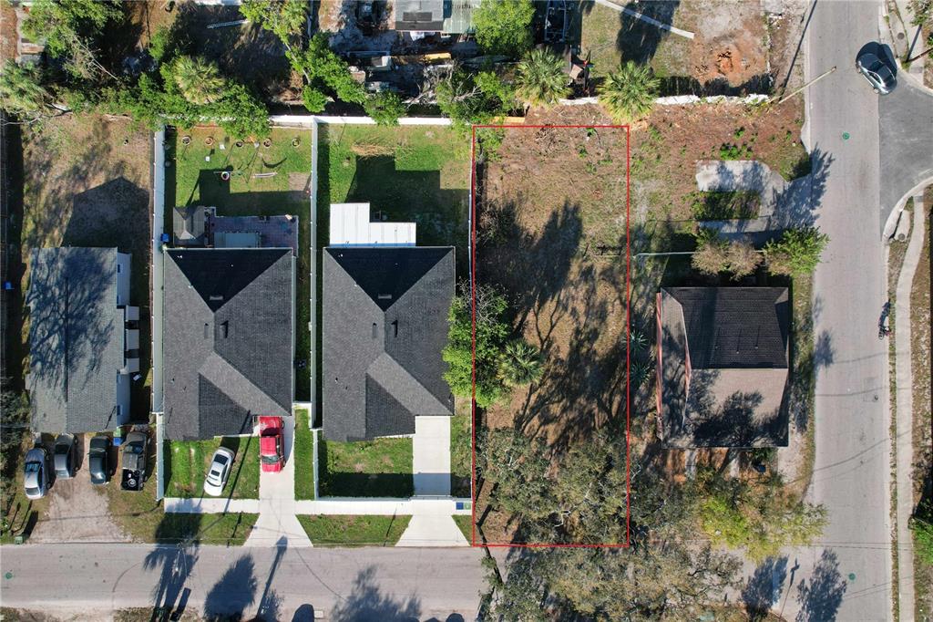 An aerial view shows a vacant rectangular lot outlined in red between two residential properties — 3222 N 48TH STREET, TAMPA, FL