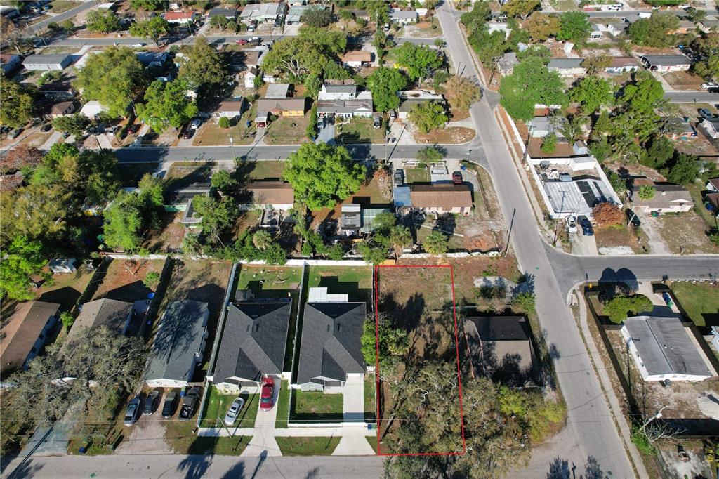 An aerial view shows a vacant rectangular lot outlined in red next to residential houses — 3222 N 48TH STREET, TAMPA, FL