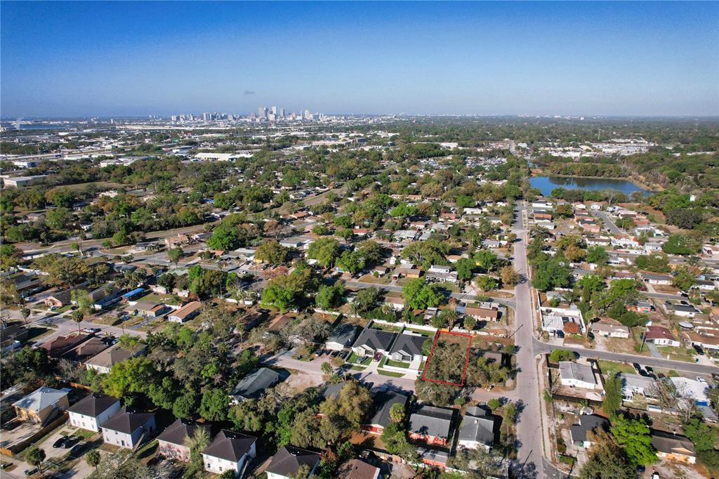 An aerial view shows a vacant residential lot outlined in red within a suburban neighborhood — 3222 N 48TH STREET, TAMPA, FL