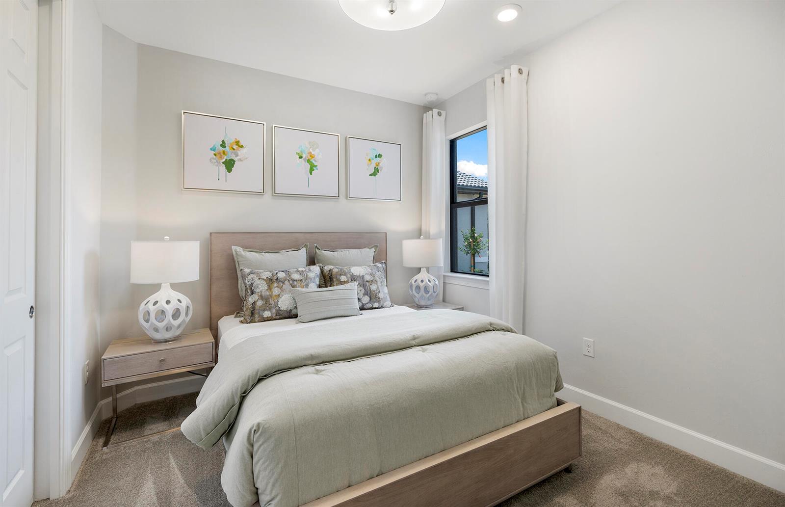 A bedroom features a queen bed, two nightstands with lamps, and three framed floral prints — 6431 Memorial Lane, Ave Maria FL 34142, AVE MARIA, FL