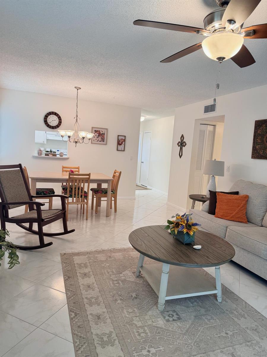A living and dining area with tile floors, a ceiling fan, and neutral furniture — 2950 SE Ocean Boulevard # 6, Stuart FL 34996, STUART, FL