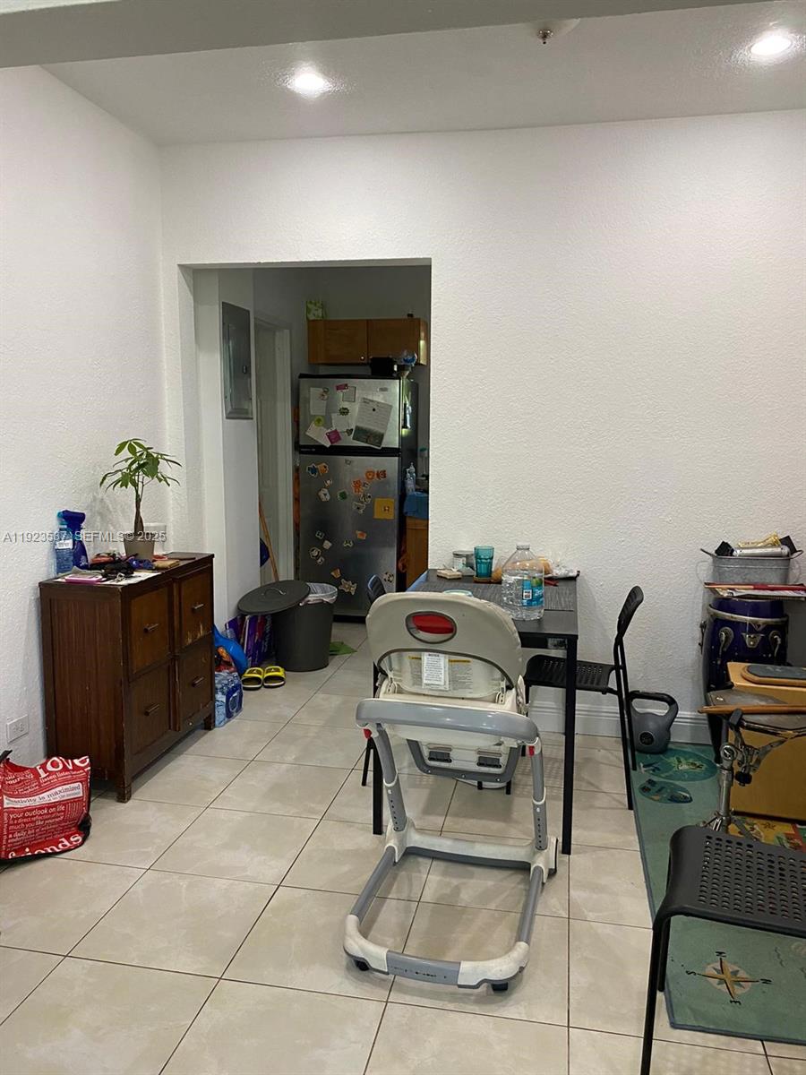 A bathroom features a stacked washer and dryer, a shower-tub combo, and a vanity — 851 80th St, Miami Beach FL 33141, MIAMI BEACH, FL