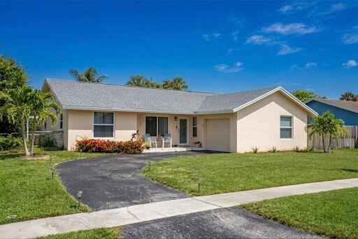 A single-story house with a light-colored exterior, a gray roof, and a paved driveway — 9544 Richmond Circle, Boca Raton FL 33434, BOCA RATON, FL