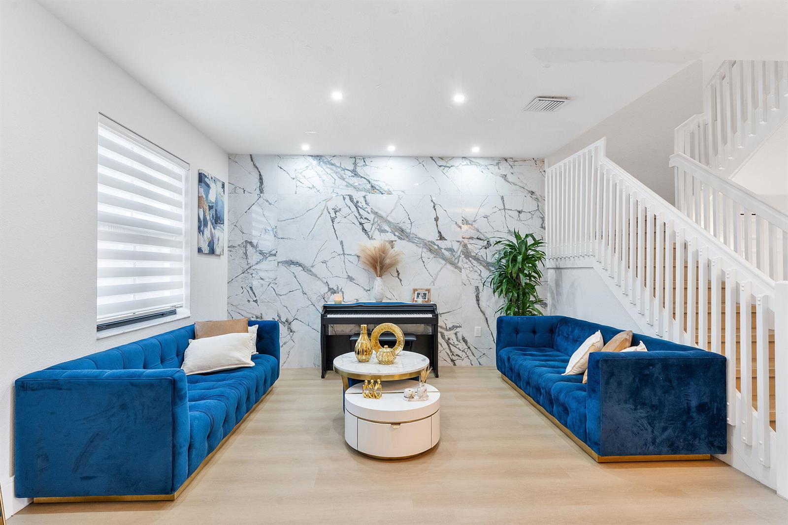A living room features two blue velvet sofas, a piano, and a marble accent wall — 3253 W 106th Terrace # 3253, Hialeah FL 33018, HIALEAH, FL
