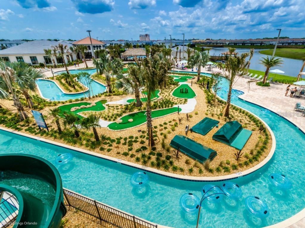 An aerial view of a resort-style pool with a lazy river and miniature golf course — 4966 WINDERMERE AVENUE, KISSIMMEE, FL