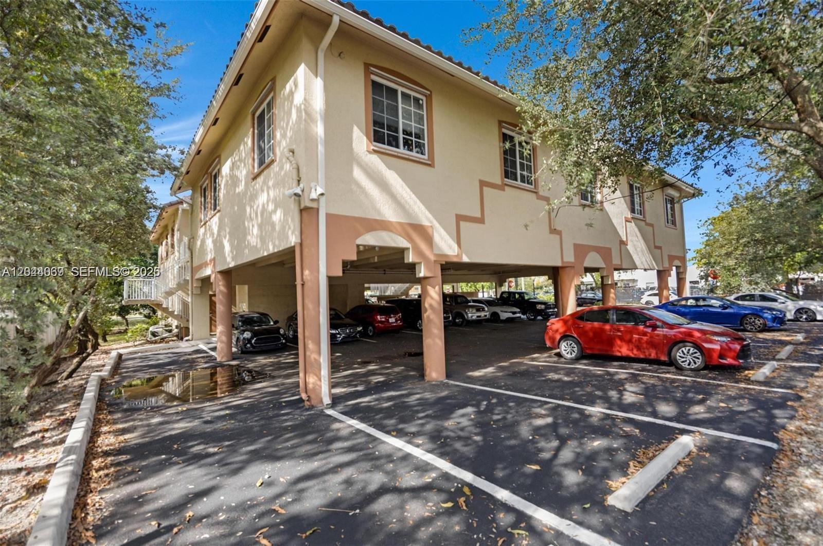 A two-story building with covered ground-level parking and an exterior staircase — 5595 Orange Dr # 101, Davie FL 33314, DAVIE, FL