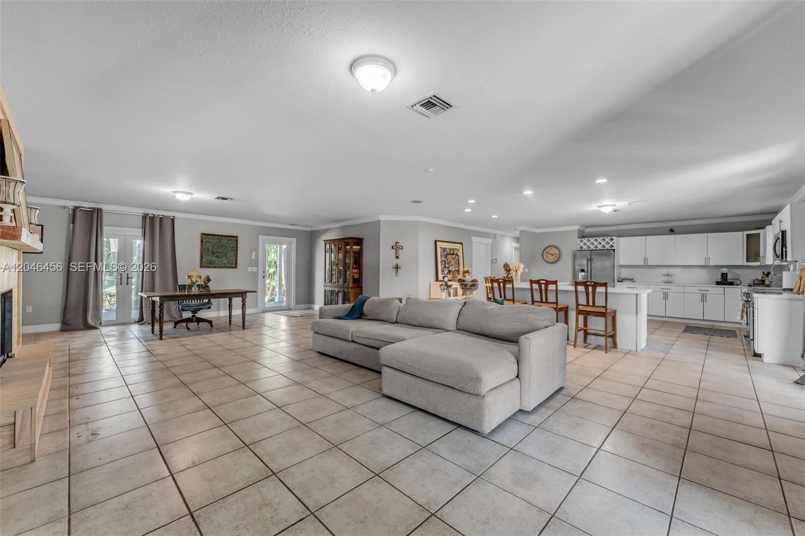 An open-concept living area features a large sectional sofa, a dining table, and a kitchen — 20076 SW 190th St, Miami FL 33187, MIAMI, FL