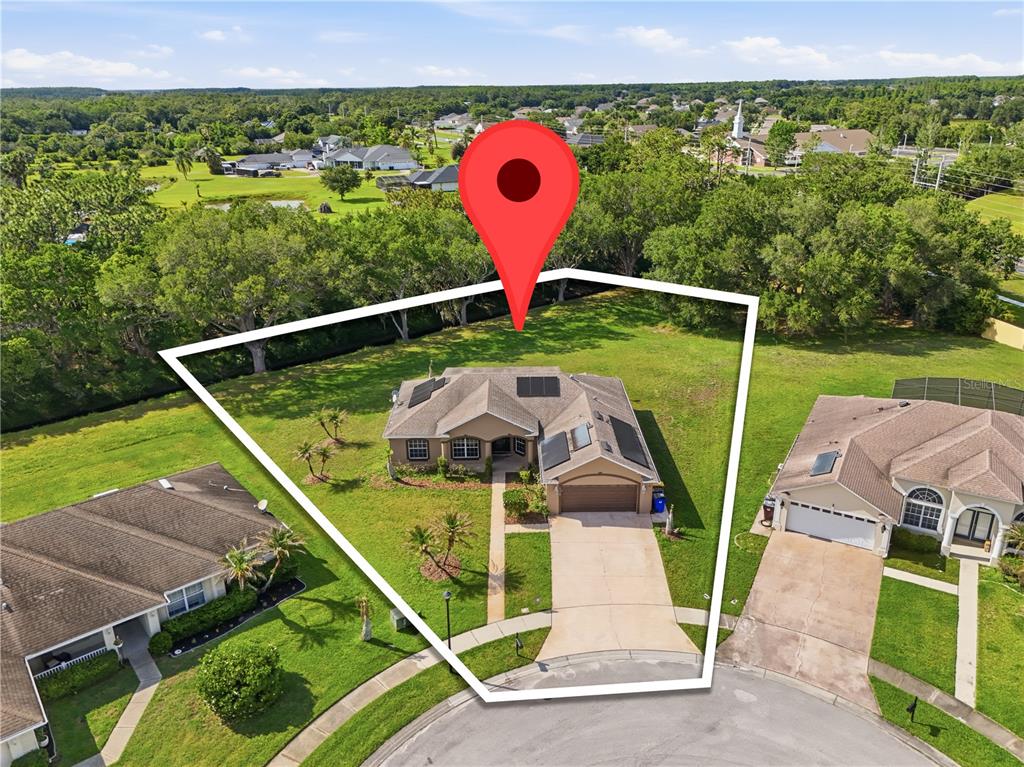 An aerial view shows a single-story house with solar panels on a corner lot — 3119 KEYSTONE POINTE COURT, ST CLOUD, FL