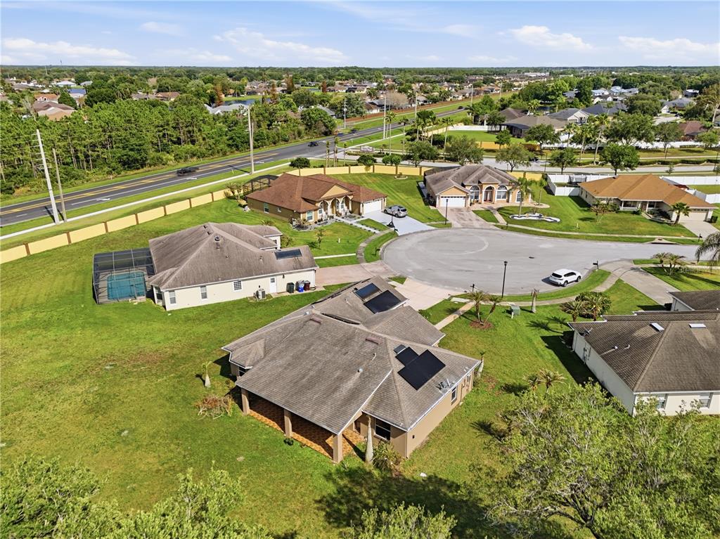 An aerial view shows several suburban houses with solar panels and swimming pools in a neighborhood — 3119 KEYSTONE POINTE COURT, ST CLOUD, FL