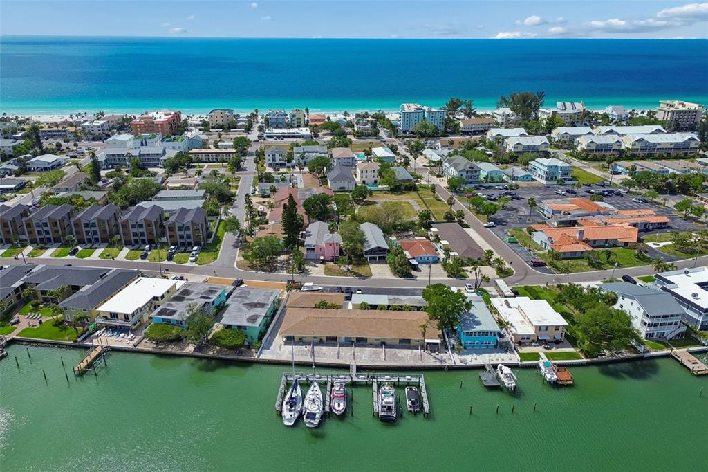 An aerial view shows a waterfront building with a boat dock along a canal — 2307 BAY BOULEVARD, INDIAN ROCKS BEACH, FL