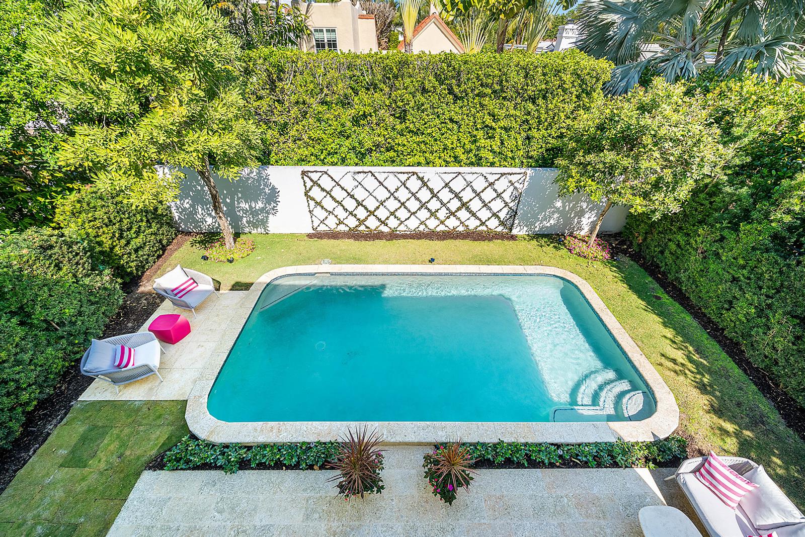 An aerial view of a backyard swimming pool surrounded by lush landscaping and patio furniture — 157 Peruvian Avenue, Palm Beach FL 33480, PALM BEACH, FL