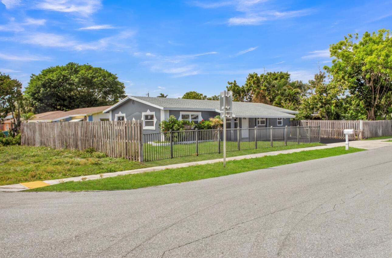A single-story gray house with a fenced yard sits along a residential street — 915 SW 3rd Street, Boynton Beach FL 33435, BOYNTON BEACH, FL