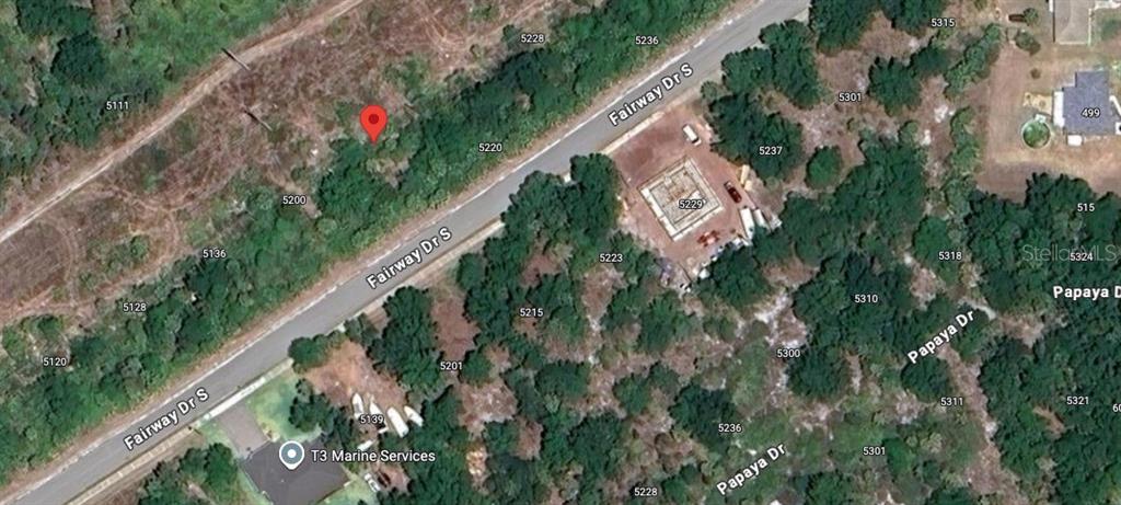 This aerial map shows a vacant lot marked with a red pin along a road — 5212 FAIRWAY DRIVE S, PUNTA GORDA, FL