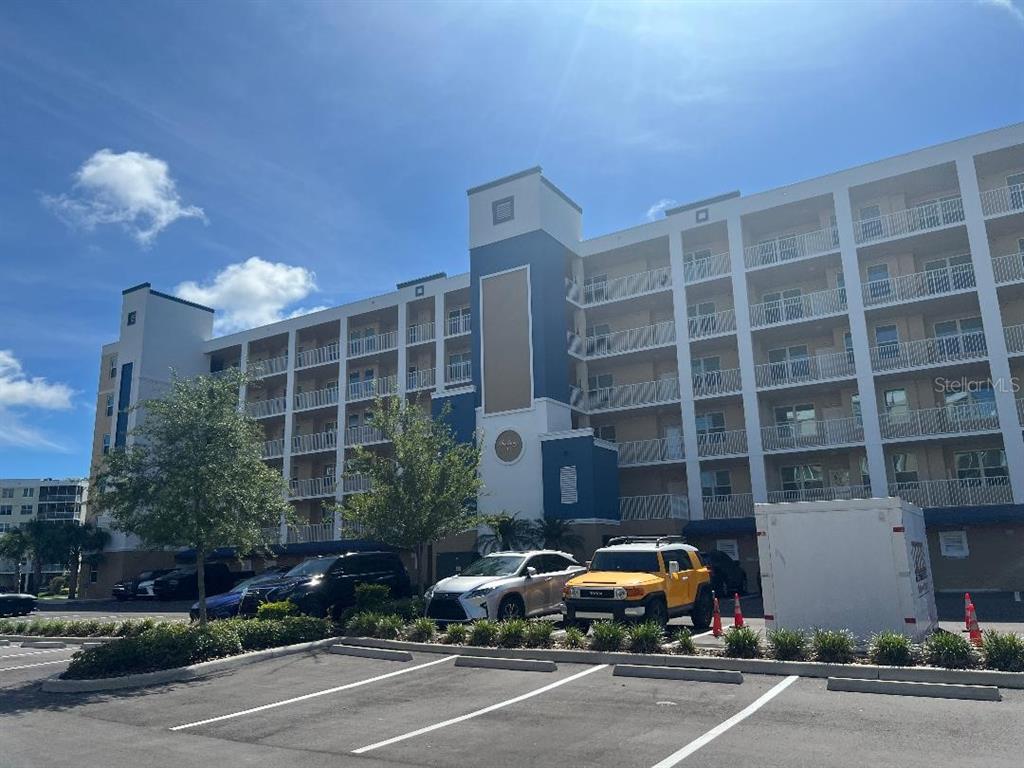 A multi-story apartment building with white balconies and a blue central tower exterior — 960 STARKEY ROAD UNIT 10305, LARGO, FL