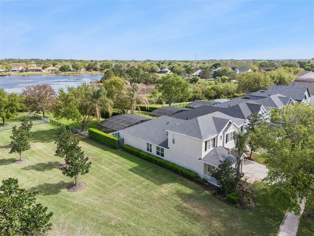An aerial view shows a suburban house with a screened pool and a large yard — 14255 SONCO AVENUE, WINDERMERE, FL