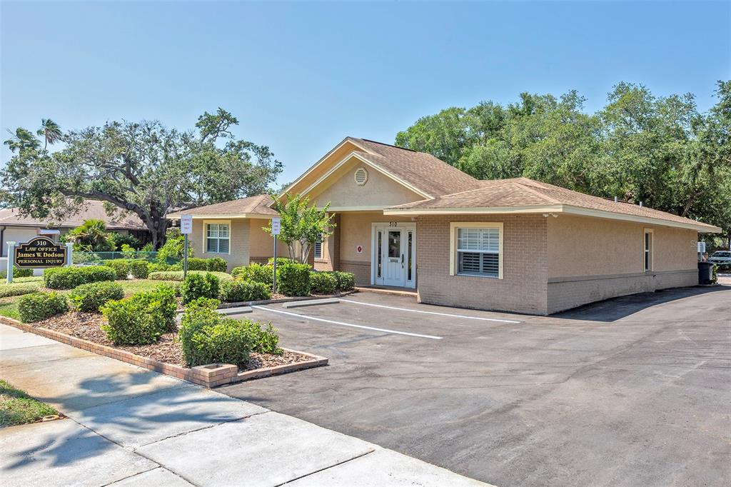 A single-story brick office building with a parking lot and landscaping in front — 310 WILDWOOD WAY, BELLEAIR, FL