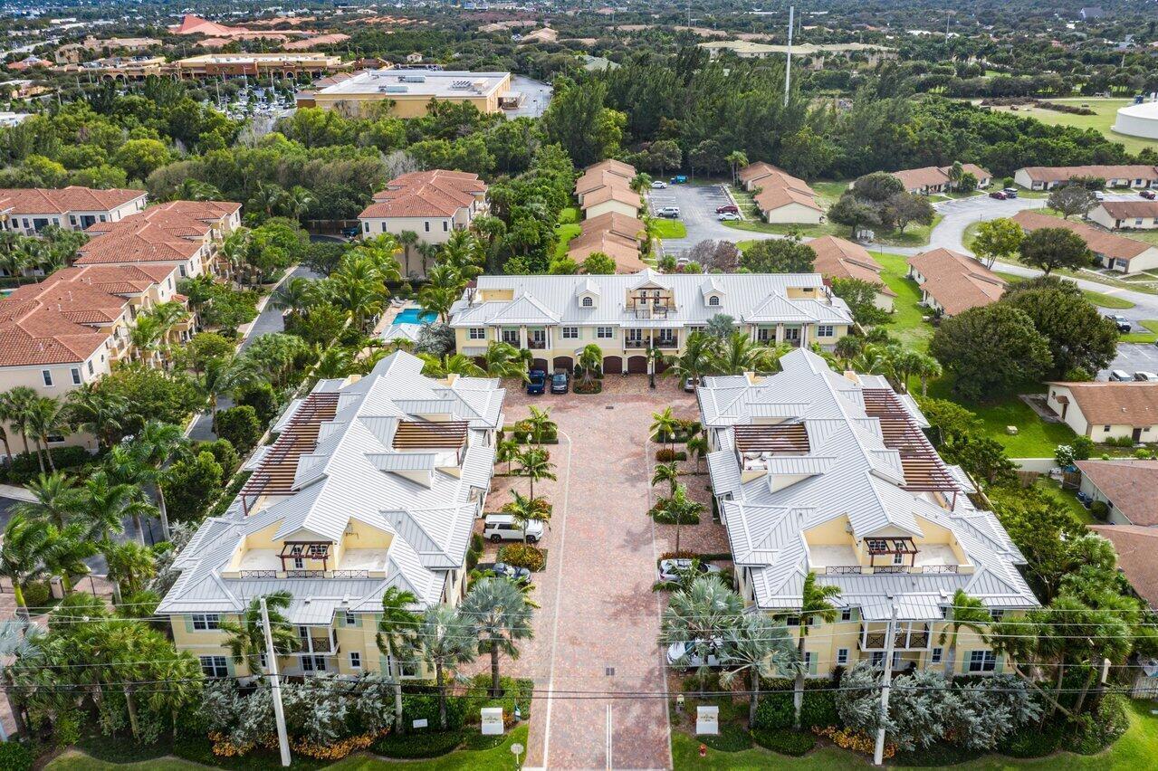 An aerial view of a residential complex with yellow buildings and metal roofs — 3770 County Line Road, Tequesta FL 33469, TEQUESTA, FL