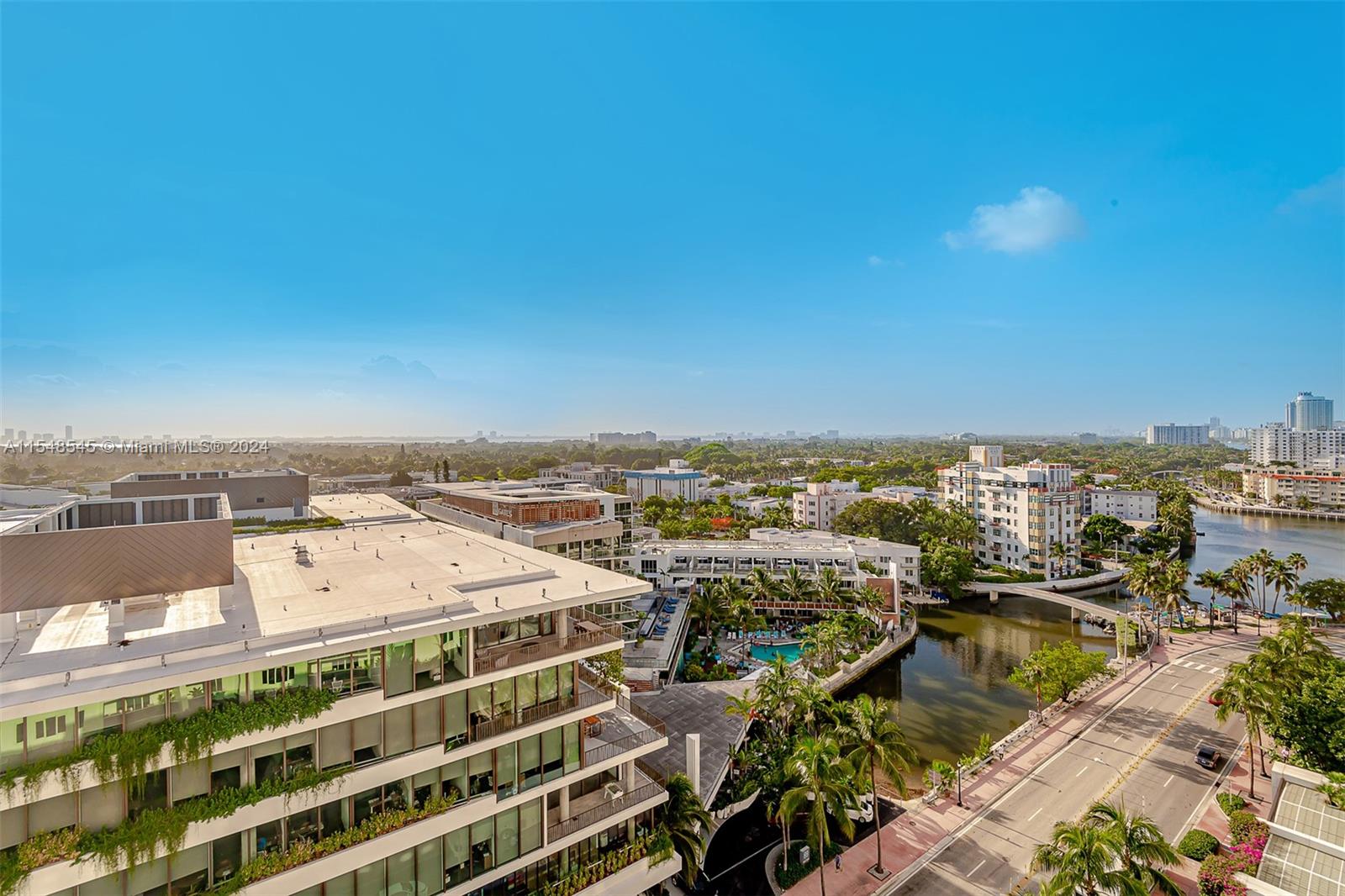 An elevated outdoor view shows a modern building, a canal, and surrounding city landscape — 2301 Collins Ave # 1230, Miami Beach FL 33139, MIAMI BEACH, FL