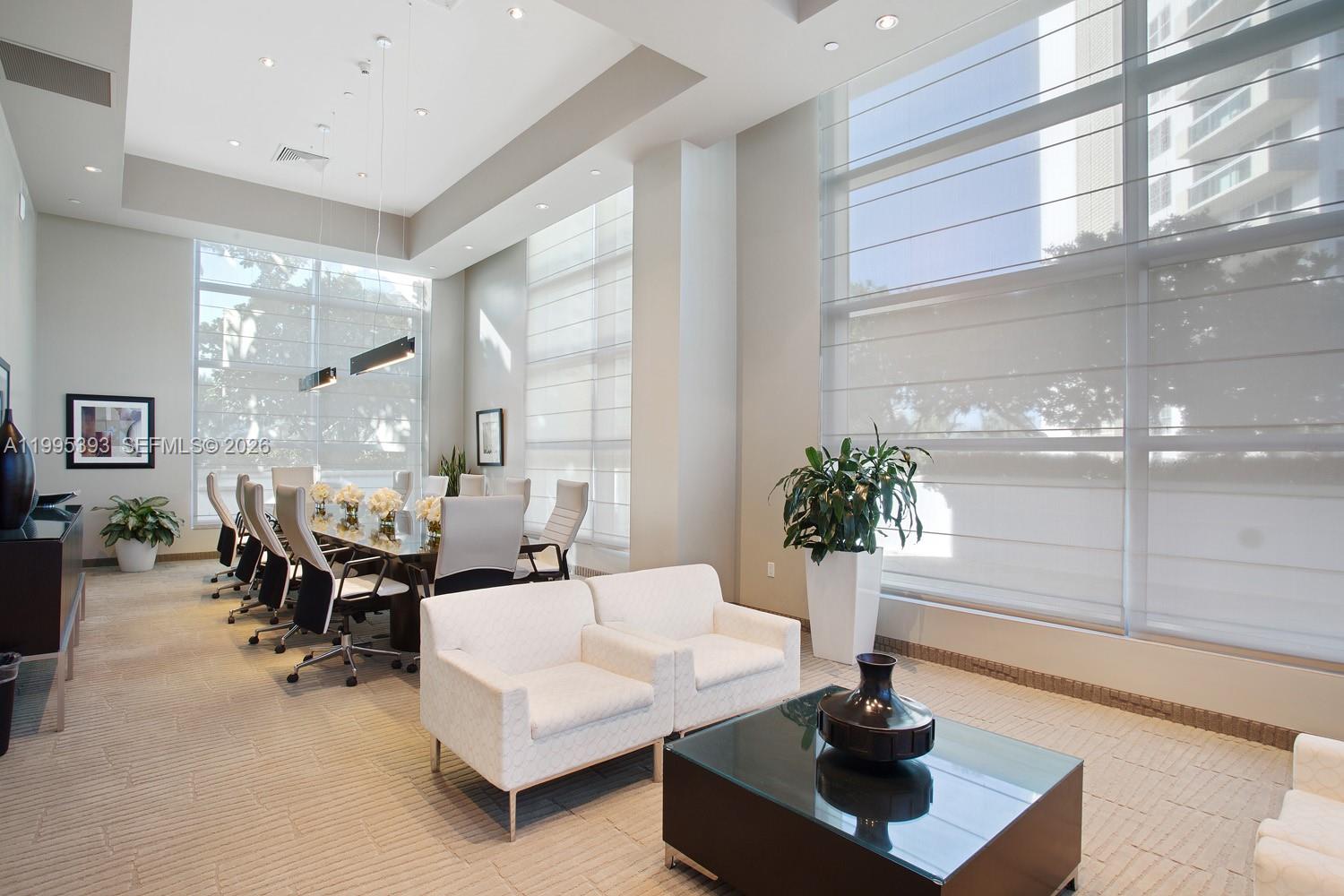 A bright conference room features a long table, white armchairs, and floor-to-ceiling windows — 3101 S Ocean Dr # 1904, Hollywood FL 33019, HOLLYWOOD, FL