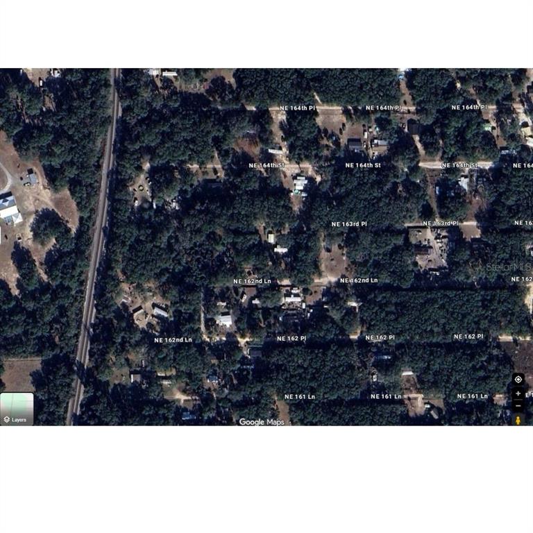 This is an aerial map view of a residential area with wooded lots and roads — NE 162ND LANE, CITRA, FL