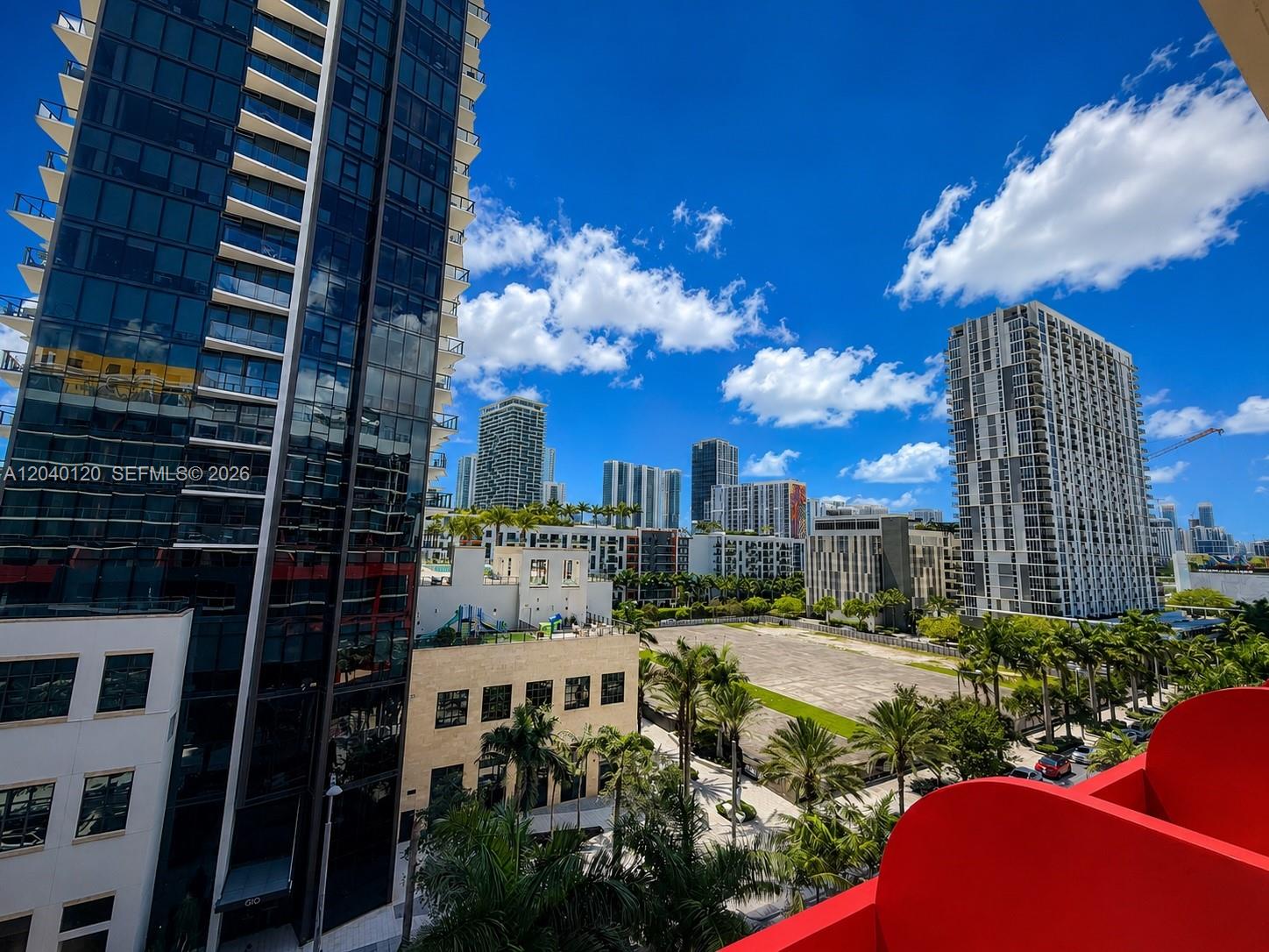 An elevated view of a city skyline with modern high-rise buildings and palm trees — 90 NE 32nd St # 705, Miami FL 33137, MIAMI, FL