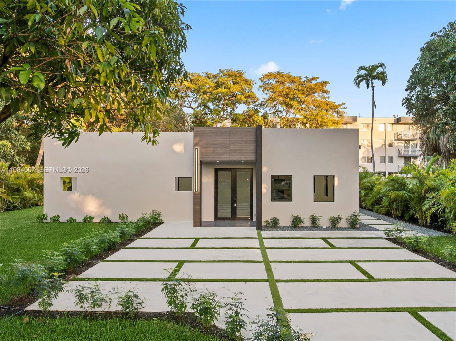 A modern, single-story house with a concrete paver driveway and a central entryway — 12335 Griffing Blvd, North Miami FL 33161, NORTH MIAMI, FL