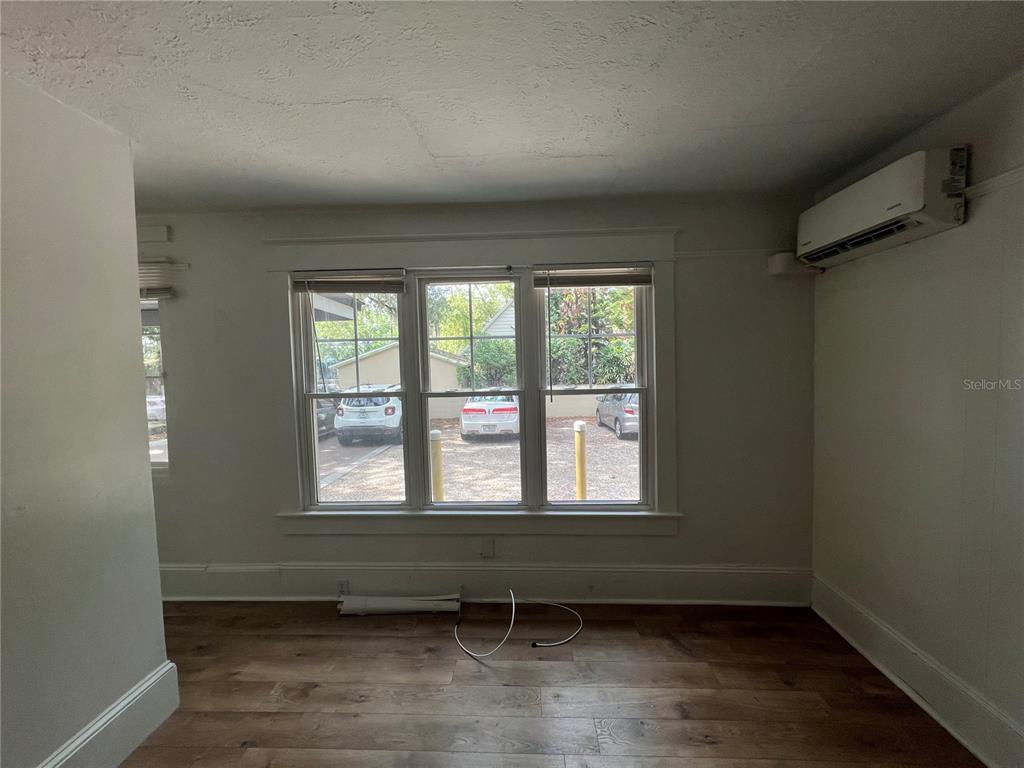 A small bathroom features a pedestal sink, a toilet, and a tiled walk-in shower — 510 E JACKSON ST UNIT 3, ORLANDO, FL