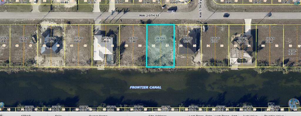 This is a satellite map view showing a vacant residential lot along a canal — 504 NW 20TH STREET, CAPE CORAL, FL
