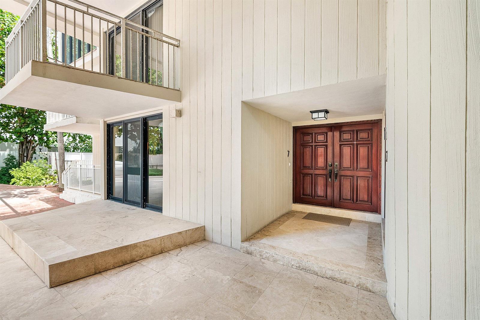 A covered entryway features a double wood door, stone flooring, and a raised patio area — 2155 S Ocean Boulevard # 7, Delray Beach FL 33483, DELRAY BEACH, FL