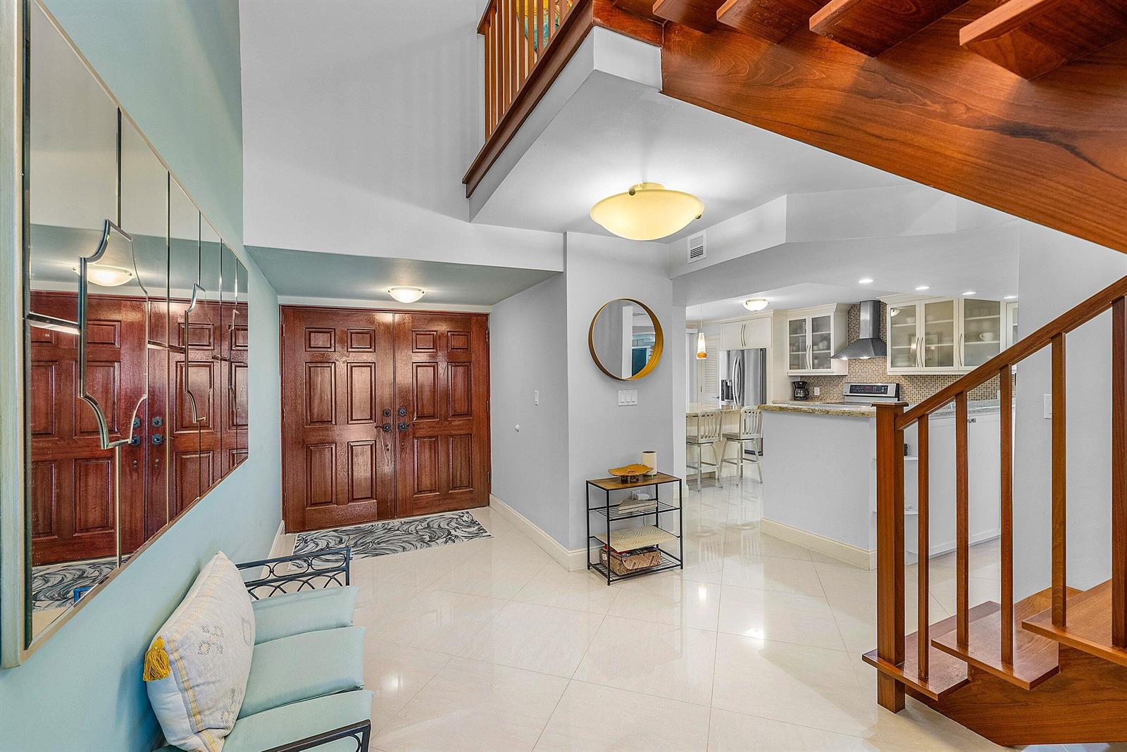 A bright foyer features a double wood door, tiled floors, and a staircase — 2155 S Ocean Boulevard # 7, Delray Beach FL 33483, DELRAY BEACH, FL