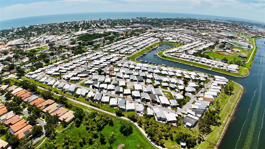 An aerial view shows a dense residential community with a canal and a baseball field — 815 S WATERWAY, VENICE, FL