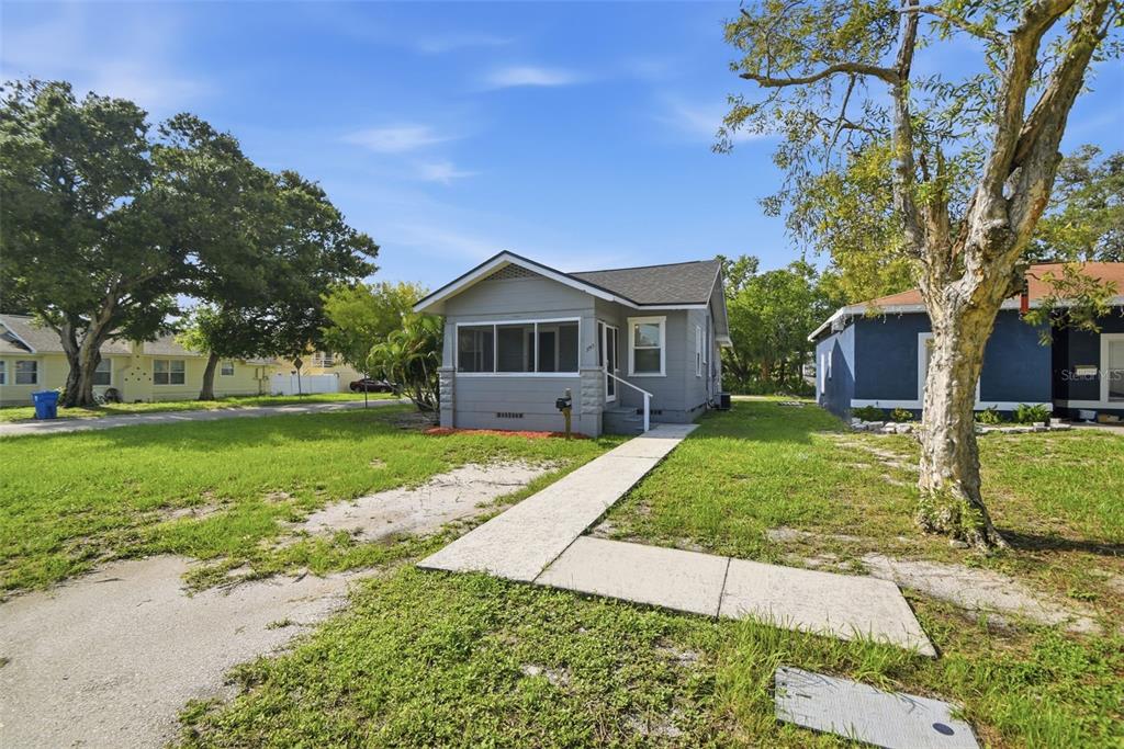 A gray single-story house with a screened front porch and a concrete walkway — 3745 S 16TH AVENUE S, ST PETERSBURG, FL