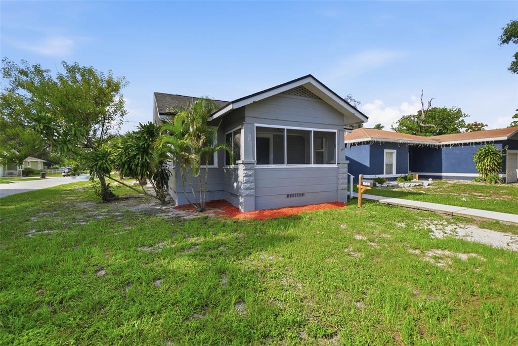 A grey single-story house with a screened-in front porch and a grassy front yard — 3745 S 16TH AVENUE S, ST PETERSBURG, FL