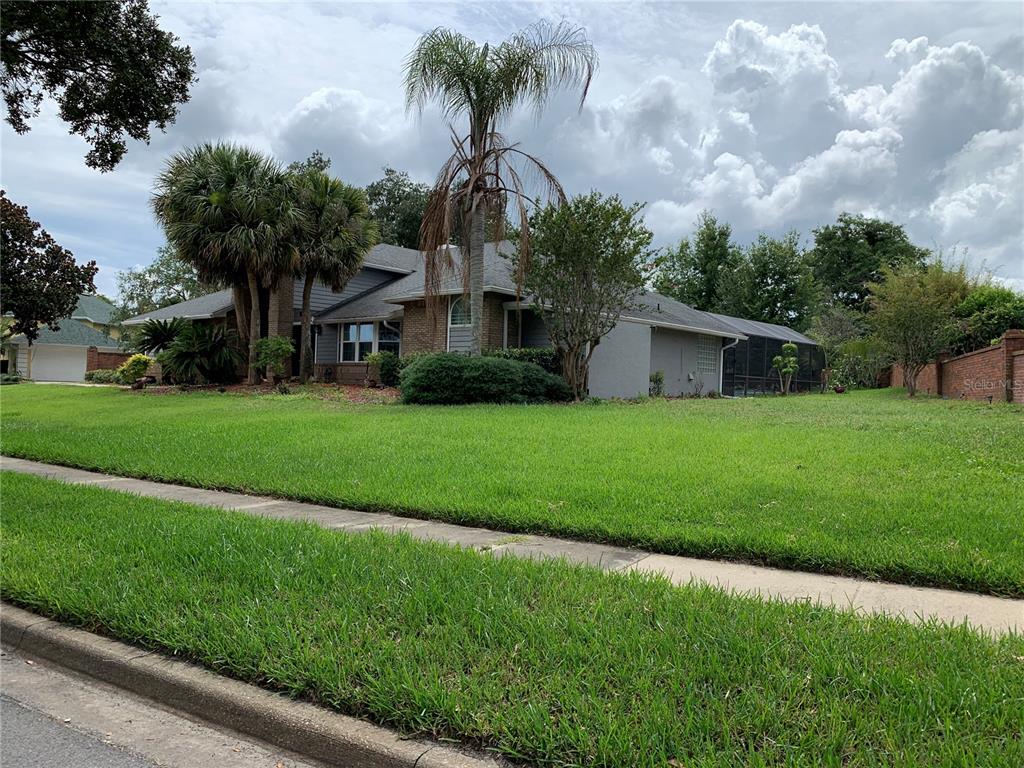 A single-story house with a brick and stucco exterior, a palm tree, and a lawn — 434 SILVER DEW STREET, LAKE MARY, FL