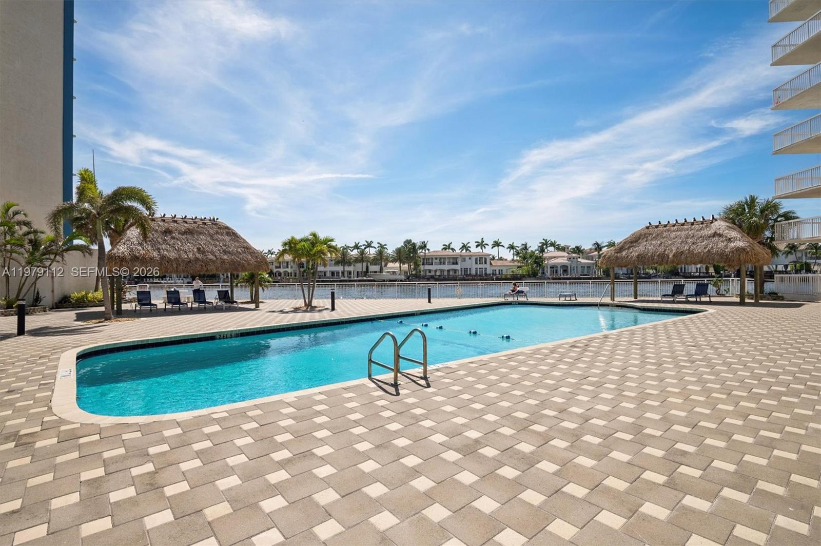 An elevated view shows a coastal city with high-rise buildings, a tennis court, and the ocean — 1500 S Ocean Dr, Hollywood FL 33019, HOLLYWOOD, FL