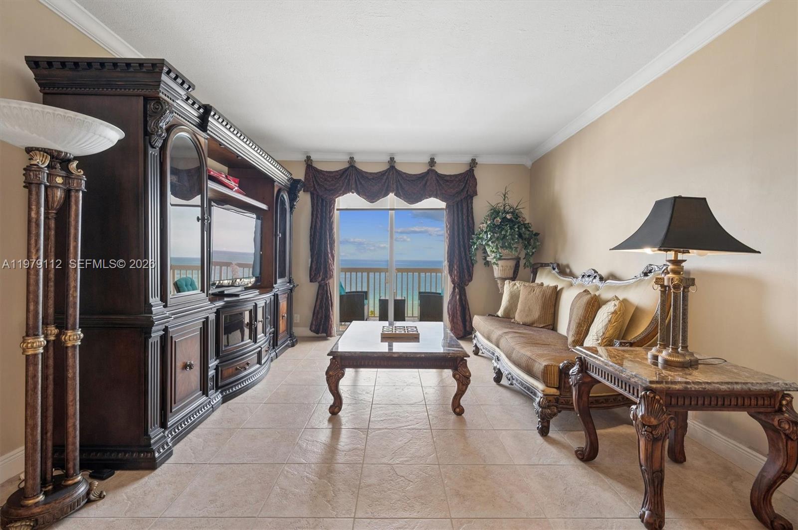 A dining room features a wooden table, ornate chairs, a chandelier, and a large wall mirror — 1500 S Ocean Dr, Hollywood FL 33019, HOLLYWOOD, FL