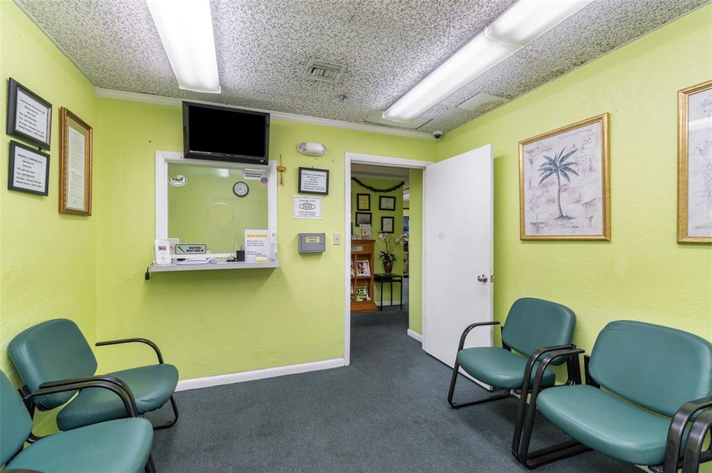 A waiting room features lime green walls, teal chairs, a reception window, and fluorescent lighting — 6005 SILVER STAR ROAD, ORLANDO, FL