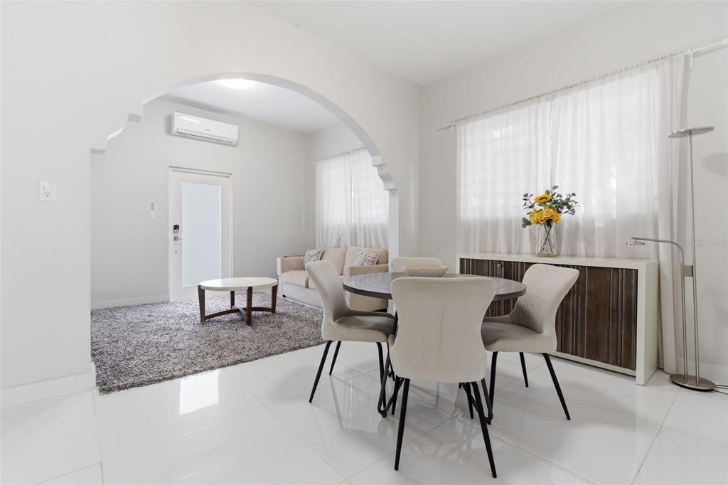 A dining area with a round table and chairs opens into a living room — 56 CALLE F KRUG CONDADO UNIT 4, SAN JUAN, PR
