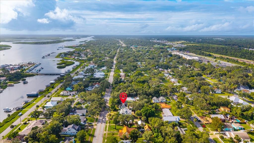 An aerial view shows a residential neighborhood with a red location pin over a house — 1116 MAGNOLIA STREET, NEW SMYRNA BEACH, FL