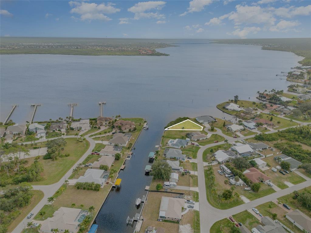 An aerial view shows a triangular waterfront lot situated at the end of a canal — 3528 FOX TERRACE, PORT CHARLOTTE, FL