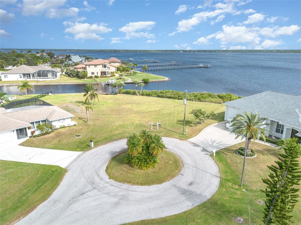 An aerial view shows a vacant waterfront lot situated within a residential cul-de-sac — 3528 FOX TERRACE, PORT CHARLOTTE, FL