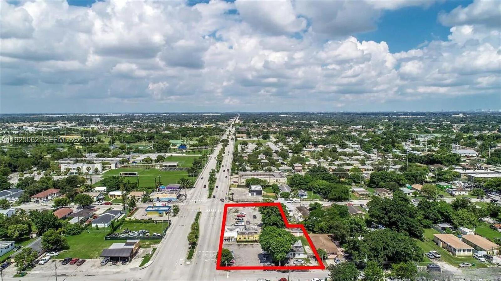 An aerial view shows a vacant commercial lot outlined in red along a city street — NW 22nd Ave, Miami FL 33147, MIAMI, FL