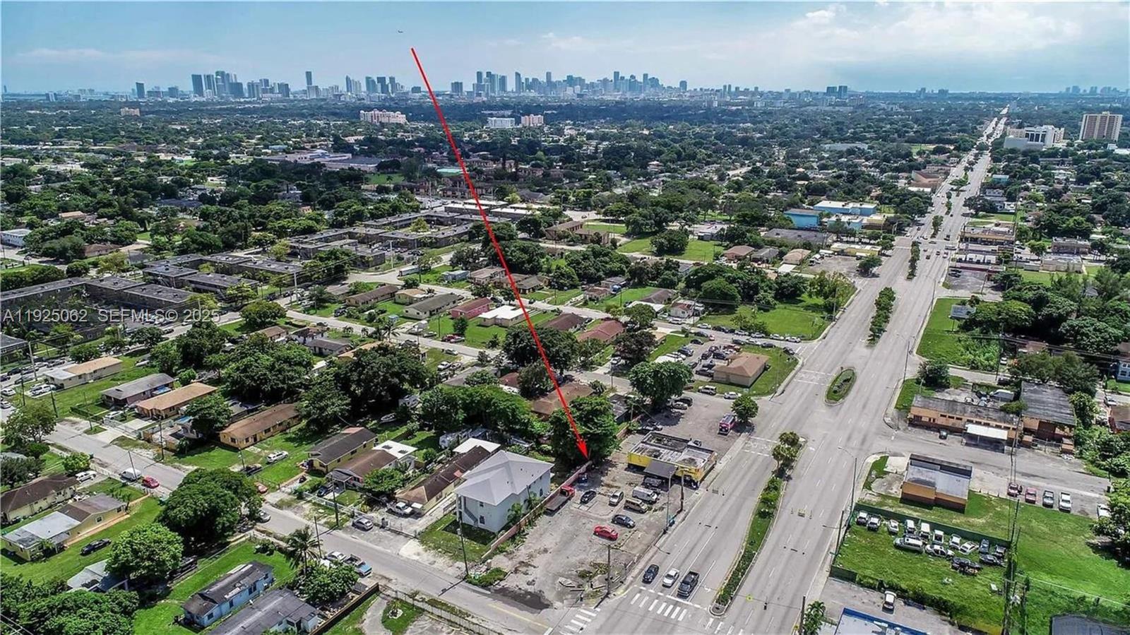 An aerial view shows a commercial lot with a building and parking near a road — NW 22nd Ave, Miami FL 33147, MIAMI, FL