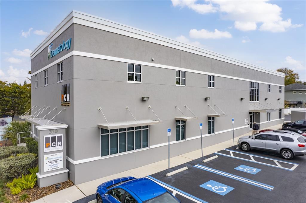 A gray two-story commercial building with a parking lot and handicap spaces in front — 310 S MACDILL AVENUE, TAMPA, FL