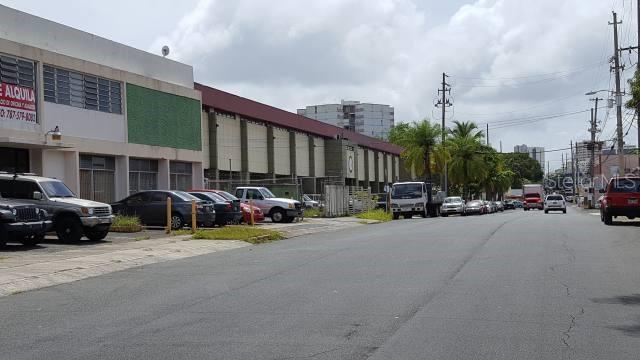 A street view showing a commercial building with parked cars and a road ahead — 204 GUAYAMA, SAN JUAN, PR