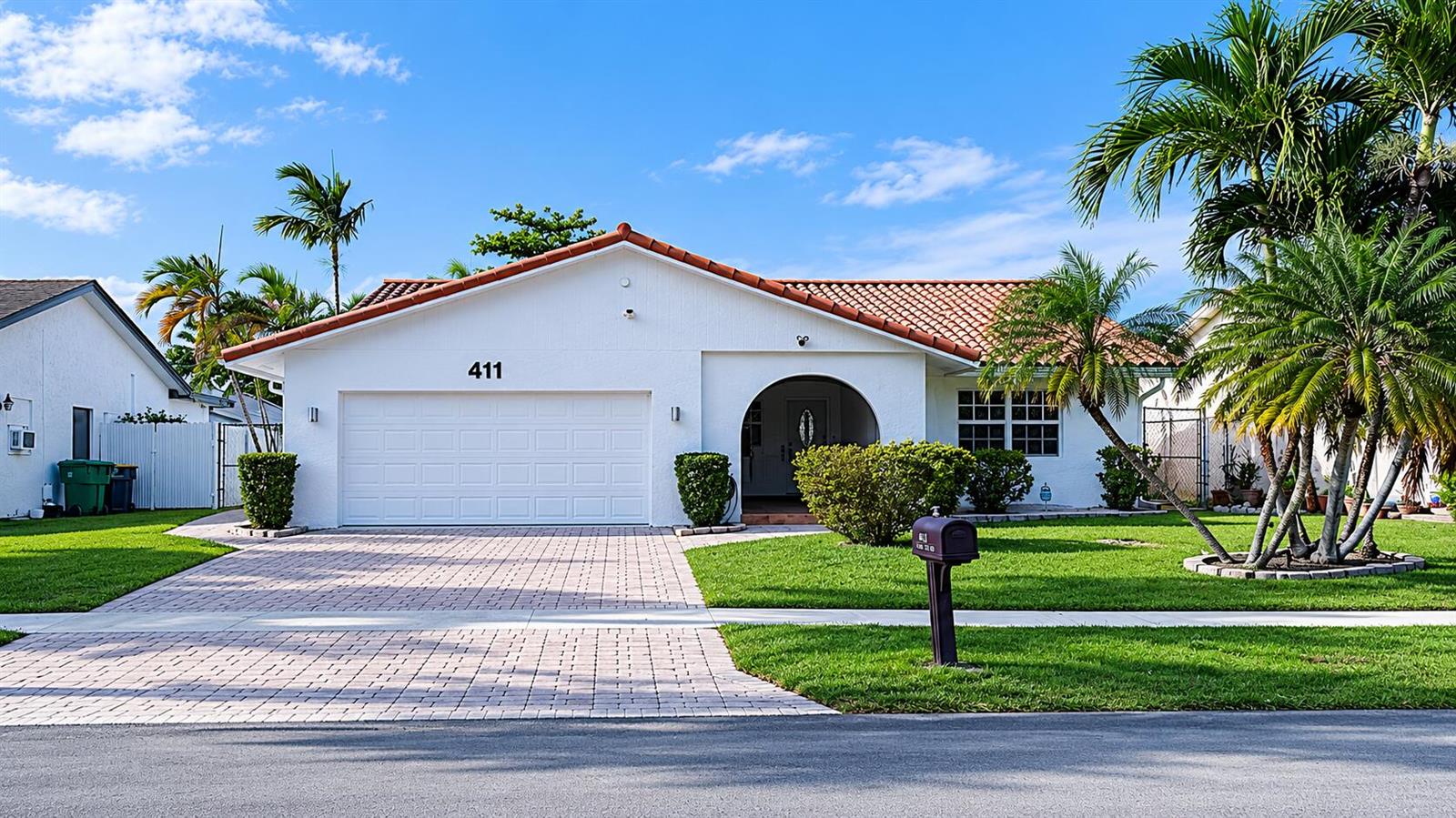 A single-story white house with a tiled roof, a two-car garage, and a paved driveway — 411 SE 4th Street, Dania Beach FL 33004, DANIA BEACH, FL