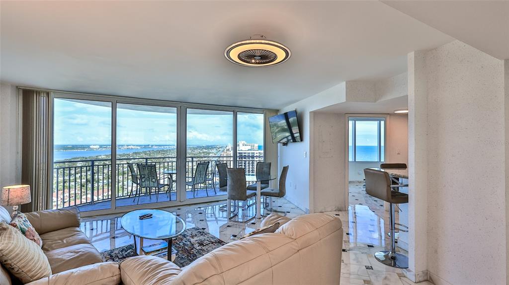 A living room with marble floors, a dining area, and a balcony overlooking the ocean — 2625 S ATLANTIC AVENUE UNIT 24NW, DAYTONA BEACH, FL