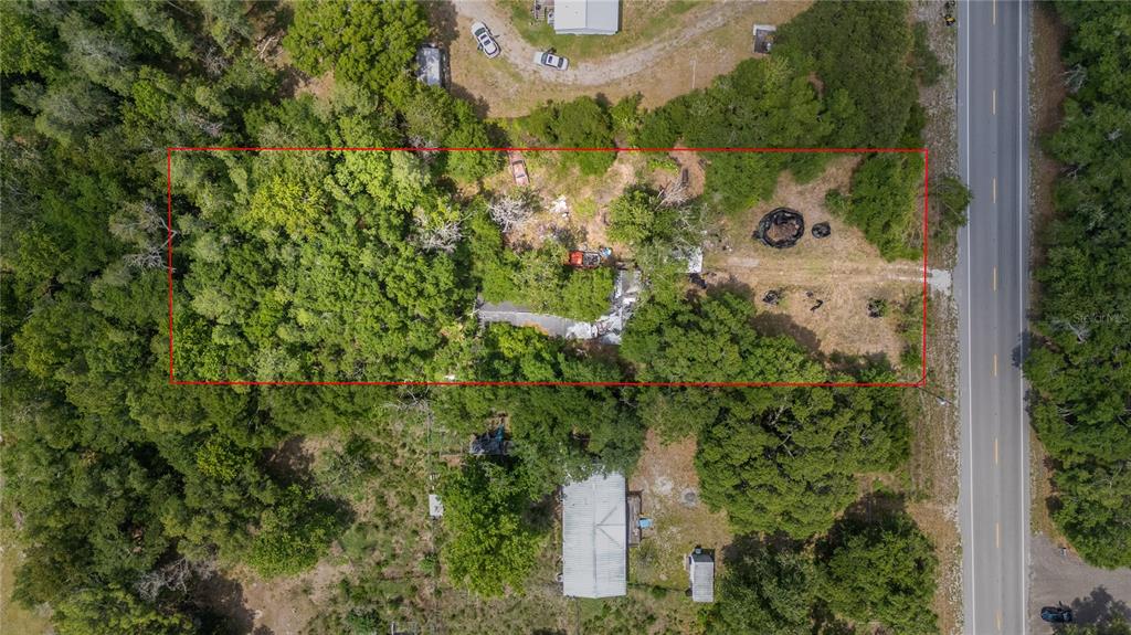 An aerial view shows a rectangular property lot outlined in red with trees and structures — 12614 ROCKRIDGE ROAD, LAKELAND, FL