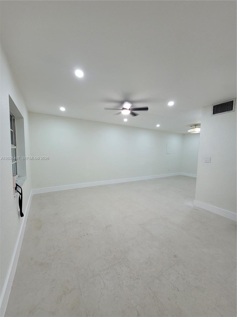 A living room features a grey sectional sofa, a round coffee table, and abstract wall art — 18000 SW 175th St # 18002, Miami FL 33187, MIAMI, FL